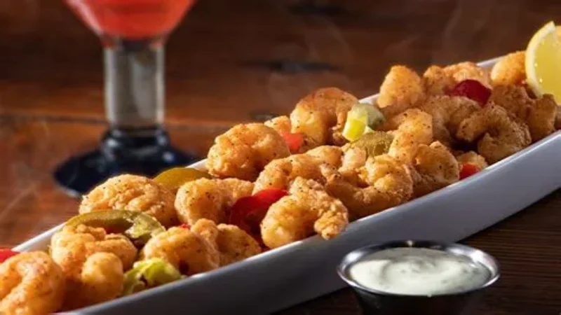 Crispy raw jumbo shrimps with ice fragments and lemon slices